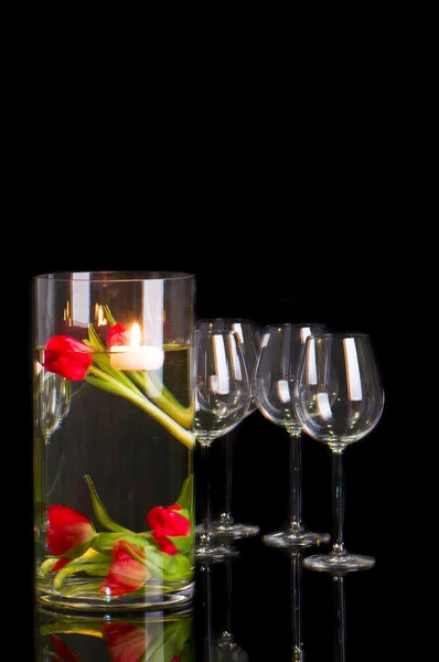 Tulips in goblet with glasses — Stock Photo, Image