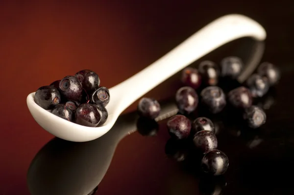Fresh bilberry in spoon on dark — Stock Photo, Image