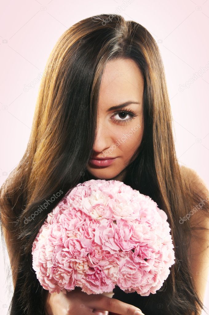 Beautiful girl with a bouquet of carnations