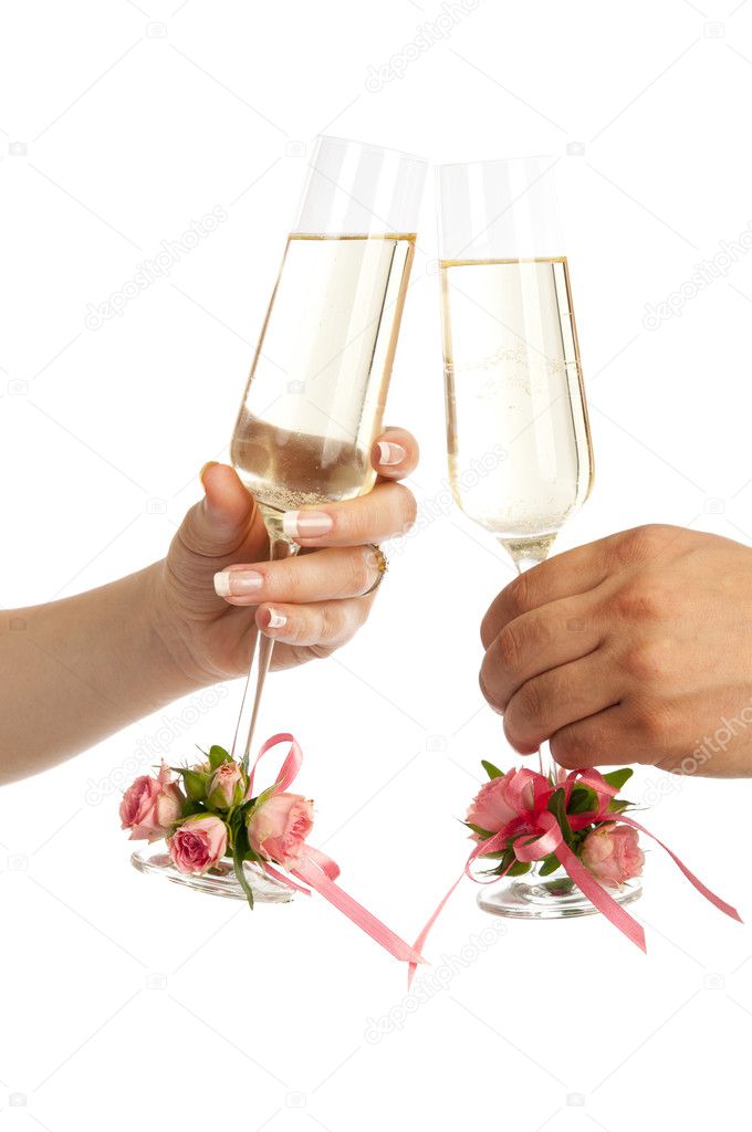 A glass of champagne in the hands of men and women