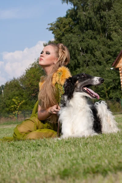 The woman in a beautiful old style dress with borzoi dogs — Stock Photo, Image
