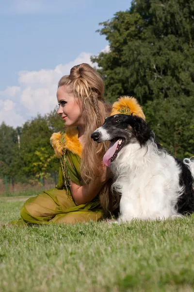 The woman in a beautiful old style dress with borzoi dogs — Stock Photo, Image