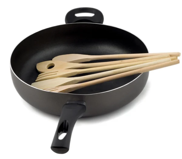Frying pan with wooden spoon — Stock Photo, Image