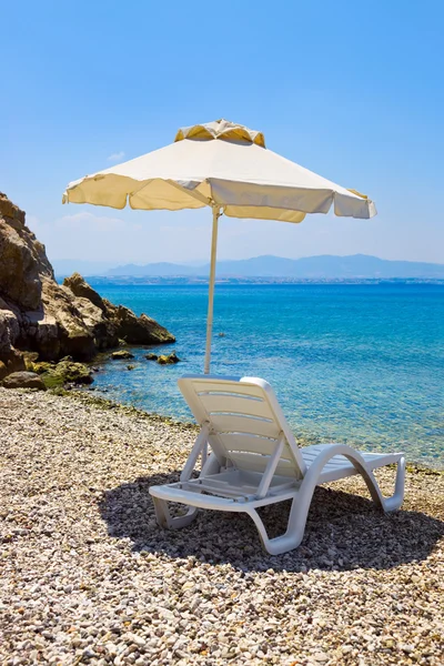 Silla y sombrilla en la playa griega — Foto de Stock