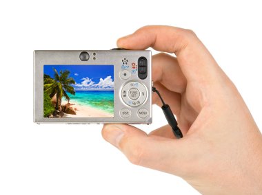 Hand with camera and beach landscape (my photo) clipart