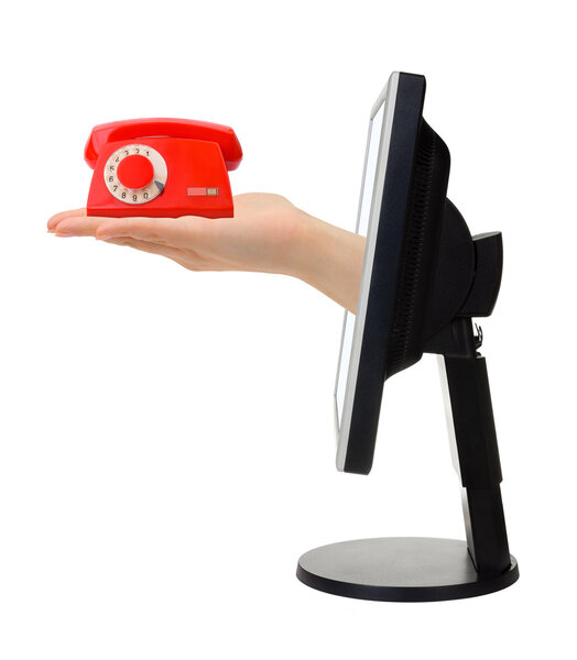 Computer screen and hand with phone