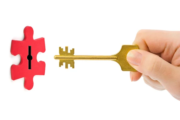 Hand with key and puzzle — Stock Photo, Image