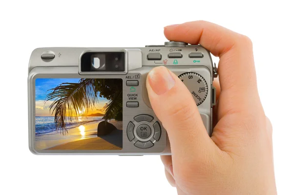 Hand with camera and beach landscape (my photo) — Stock Photo, Image