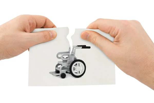 Hands tear picture with wheelchair — Stock Photo, Image