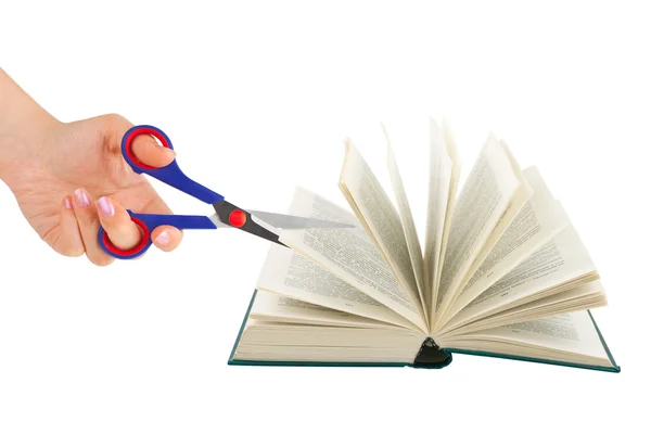 Hand with scissors cutting book — Stock Photo, Image