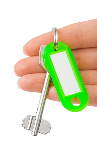 Mão e chave com etiqueta — Fotografia de Stock