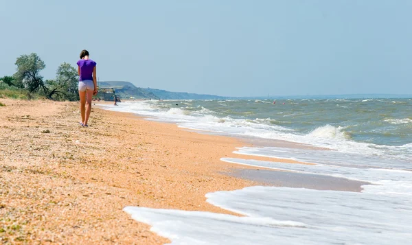 stock image The girl walks on a beach