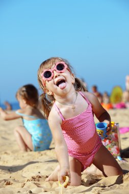 Child playing at the beach clipart