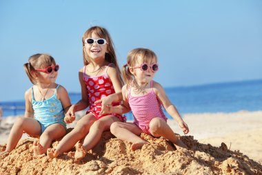Kids playing at the beach clipart