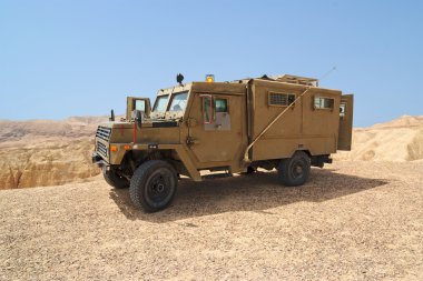 Israeli army Humvee on patrol in the Judean desert clipart