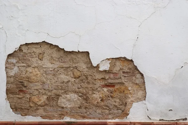 stock image Stone wall with peeling plaster