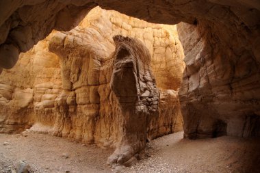Sunlit cave in desert canyon clipart