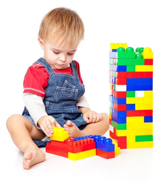A funny boy is playing with lego — Stock Photo, Image