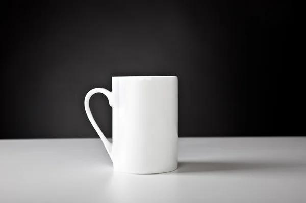 A white cup is on the table — Stock Photo, Image