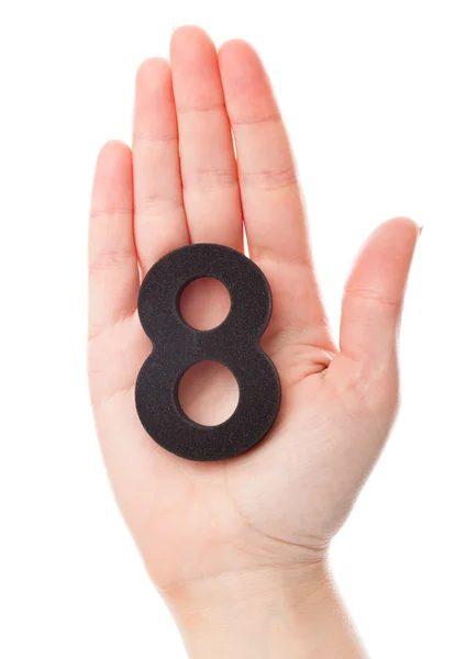 Um número oito na mão — Fotografia de Stock