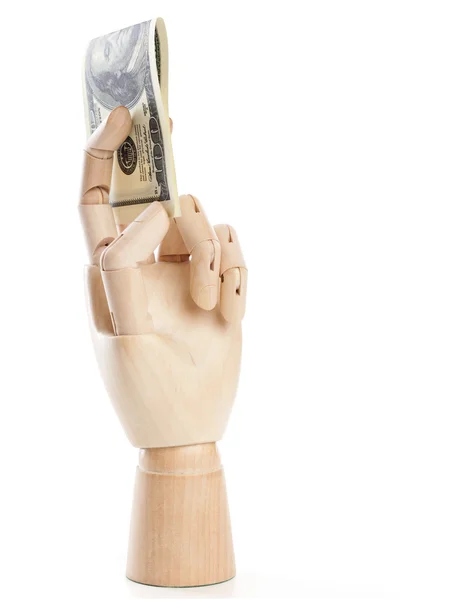 Uma mão de madeira com dólares — Fotografia de Stock