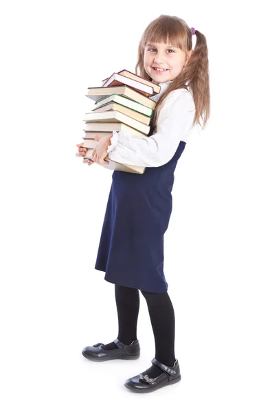 En leende flicka med en enorm hög av böcker — Stockfoto