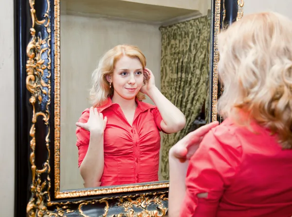 Reflection of young woman in a mirror — Stock Photo, Image