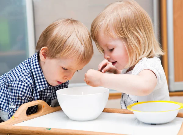 Funny children are eating dessert — Stock Photo, Image