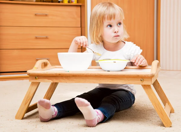 Ein kleines Mädchen isst — Stockfoto
