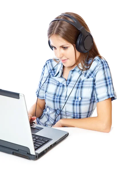 Red-haired teen-girl listen to music in headphones with laptop — Stock Photo, Image