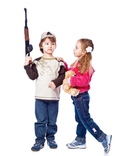 A girl is kissing a boy with the gun — Stock Photo, Image