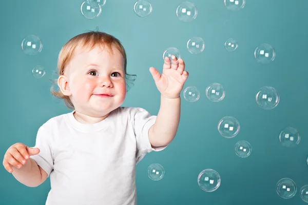A little funny boy is playing with bubbles — Stock Photo, Image