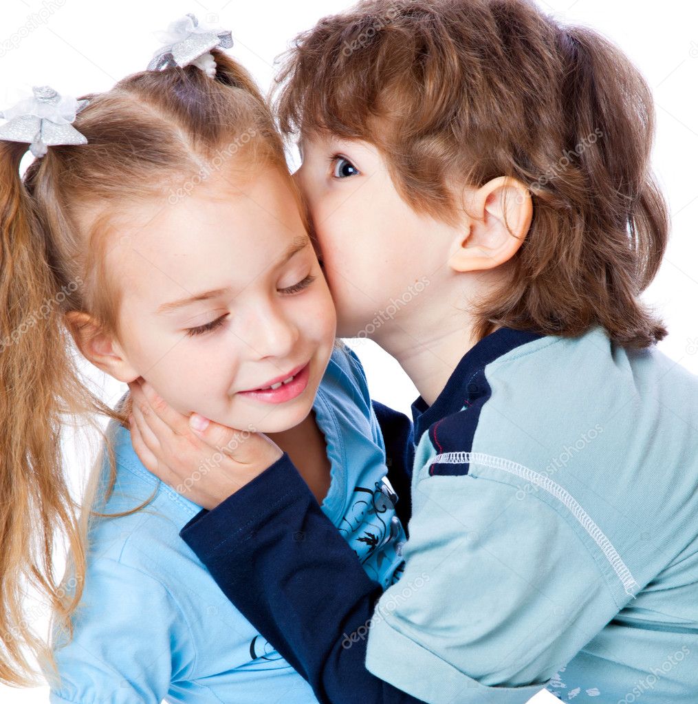 A boy is kissing a little girl