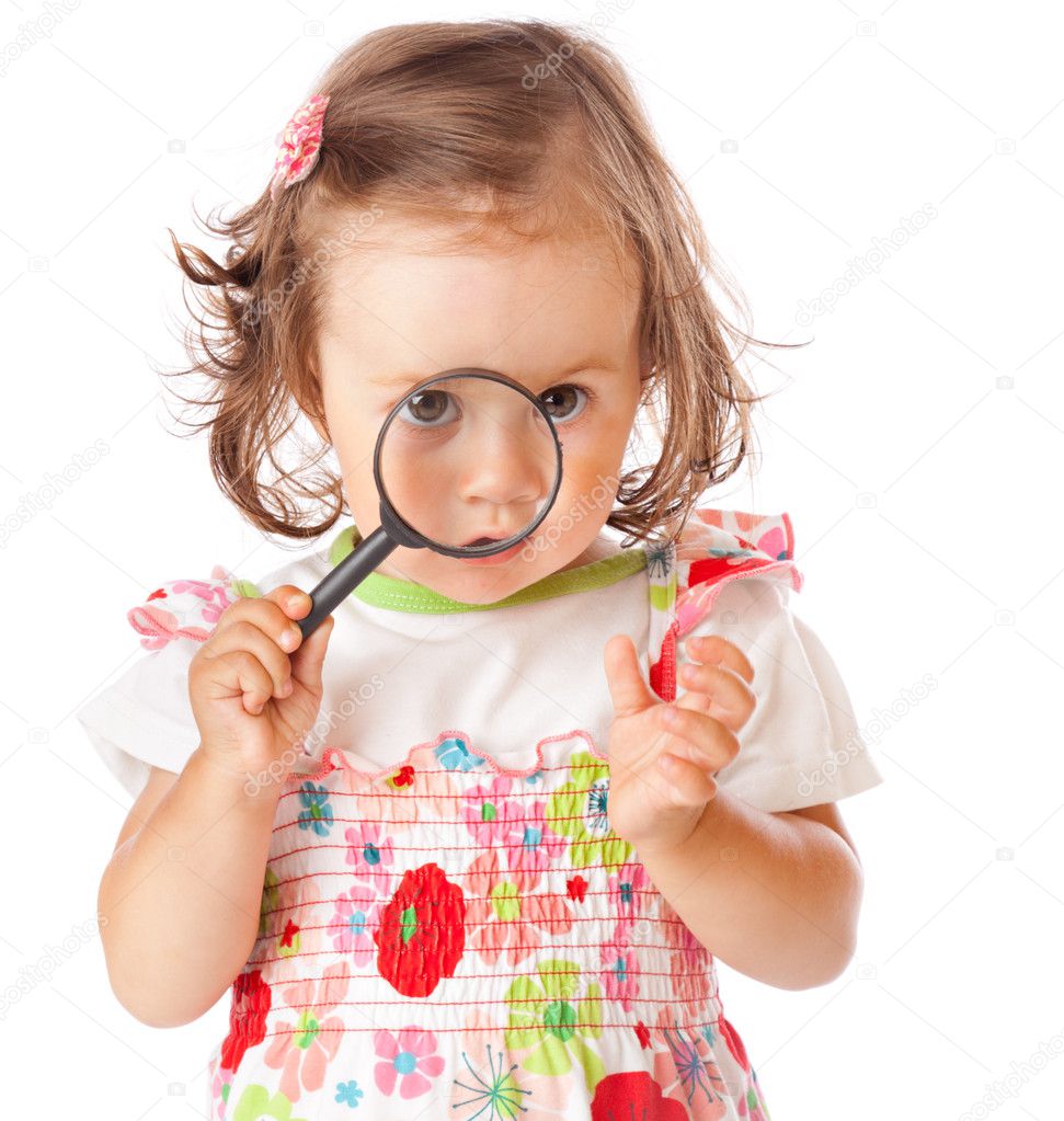 A little girl is looking through the loupe