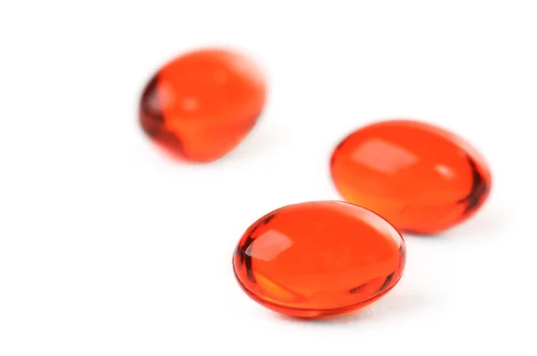 Red pills on white background — Stock Photo, Image