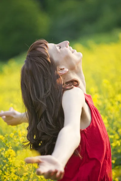 Kobieta w polu żółty kwiat — Zdjęcie stockowe