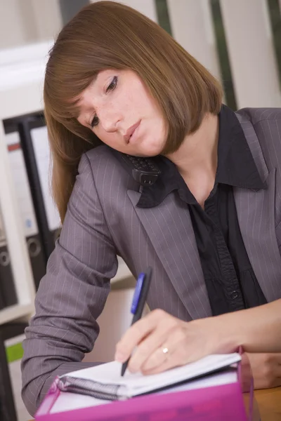 Busy secretary with phone — Stock Photo, Image