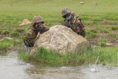 Soldiers covering behind the rock clipart