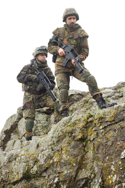 Soldiers moving on mountain with guns — Stock Photo, Image
