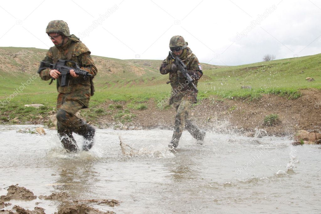 Soldiers running across the water