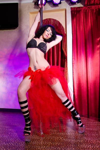 Stripper girl pole dancing in costume Stock Picture