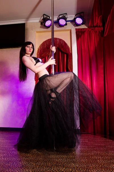 Stripper girl pole dancing in costume — Stock Photo, Image