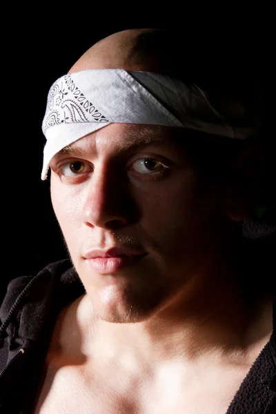 Portrait of a thug in headband at night — Stock Photo, Image