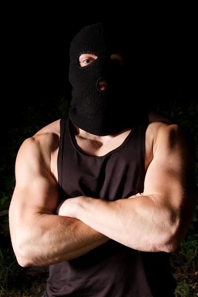 Pumped thug in black mask outdoors at night — Stock Photo, Image