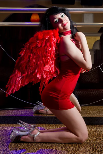 Striptérka v červené pózuje na scéně — Stock fotografie