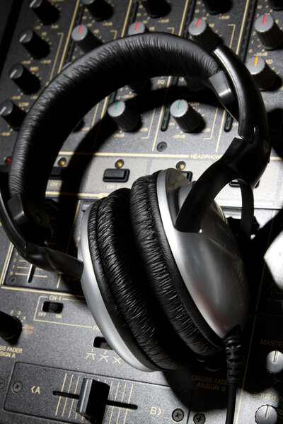 Professional DJ stereo headset on mixing controller