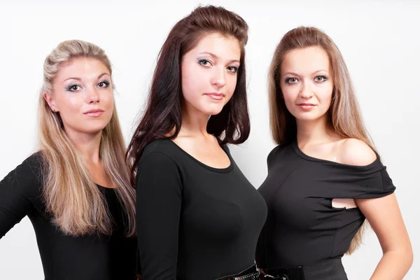 Grupp tre sexiga damer i svarta kropp kostymer Stockfoto