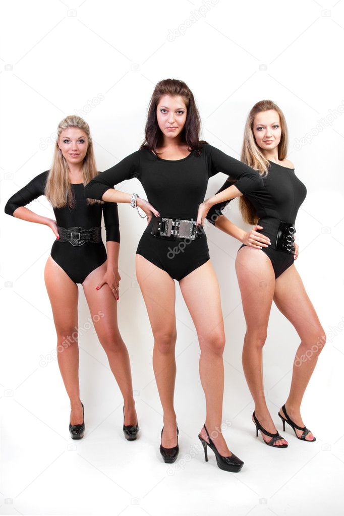 Group of three sexy ladies in black body suits on heels Stock