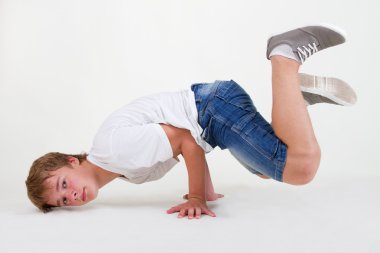 Strong teen b-boy standing in freeze clipart