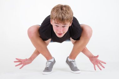 Teen b-boy standing on his tiptoes clipart